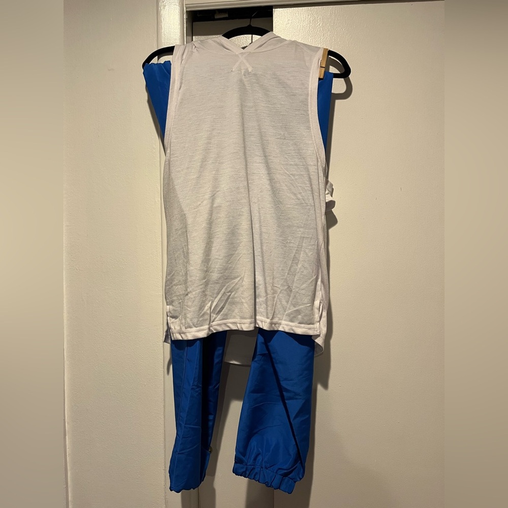 Weissman, MA, blue baggy pants, white sleeveless hooded